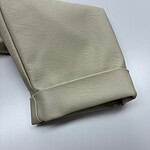 Close-up of beige leather fabric, showcasing smooth texture and high-quality material suitable for fashion and apparel projects.