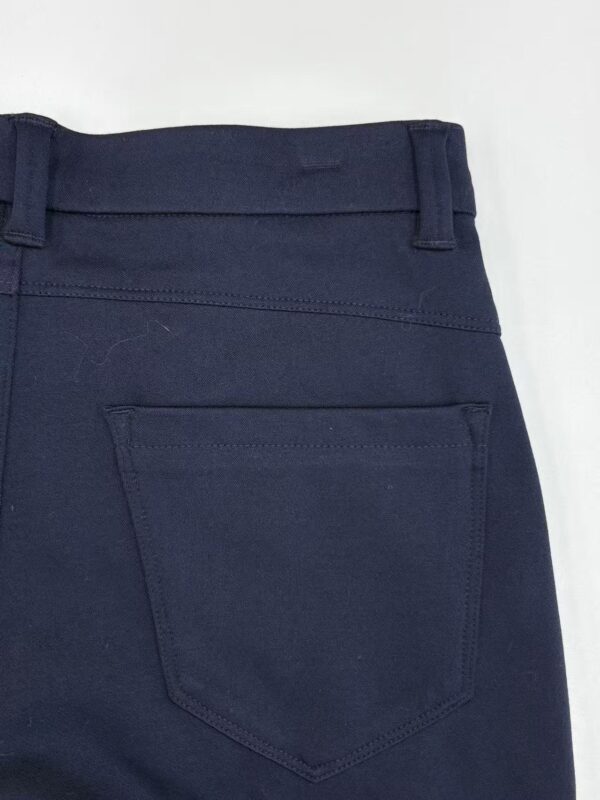 Close-up of navy blue women's pants showing back pocket and waistband details, suitable for casual or professional wear.