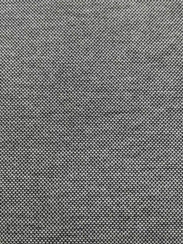 Detailed close-up of a textured fabric surface with small, evenly spaced dots in black and white.