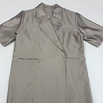 Luxurious beige satin coat with a sleek design, featuring a lapel collar and long sleeves, perfect for formal or casual wear.