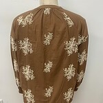 Elegant brown blouse with white floral embroidery, perfect for casual or semi-formal occasions, showcasing stylish and comfortable fashion.