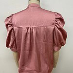 Pink women's blouse with puff sleeves and classic design, perfect for casual or formal wear, displayed on a mannequin.