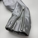 Close-up of a silver leather jacket sleeve featuring prominent silver zippers, showcasing modern fashion and high-quality craftsmanship.
