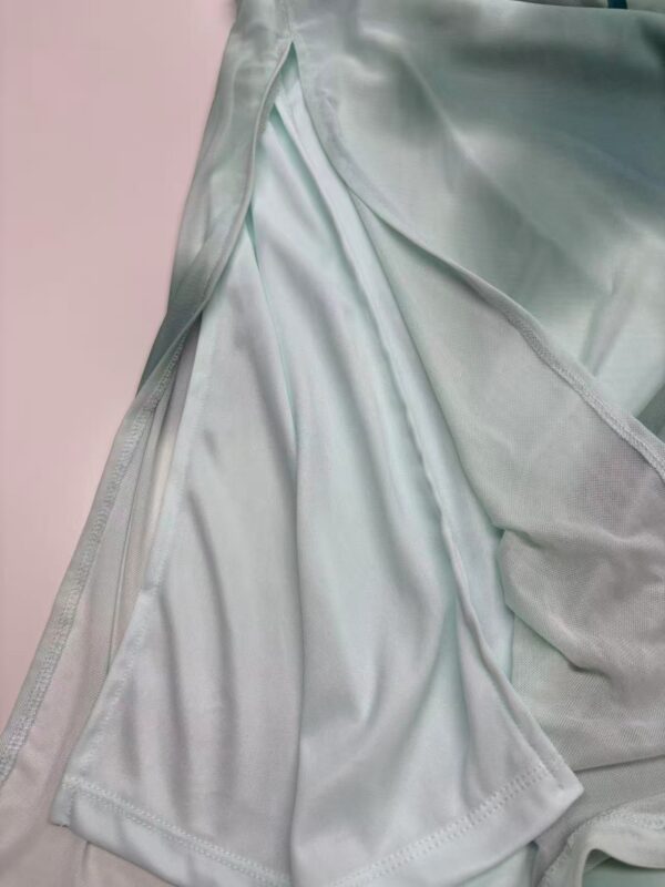 Close-up of luxurious mint green satin fabric with smooth texture and subtle sheen, perfect for high-end fashion and evening wear.