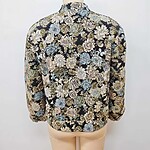 Women's floral patterned jacket with intricate design, suitable for fashion-forward outfits, displayed on a mannequin against a plain background.