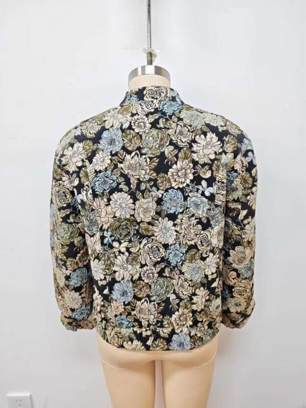Women's floral patterned jacket with intricate design, suitable for fashion-forward outfits, displayed on a mannequin against a plain background.