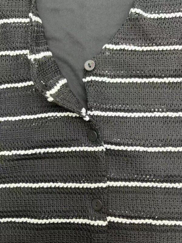 Close-up of a black and white striped knitted cardigan with buttons, perfect for casual or office wear.