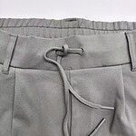 Close-up of grey men's pants with adjustable drawstring, suitable for casual or athletic wear, featuring a comfortable waistband and modern design.