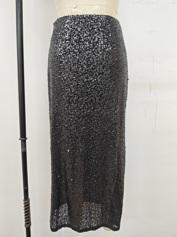 Stylish black maxi skirt adorned with sequins, perfect for evening wear or special occasions, showcasing a sleek and glamorous look.