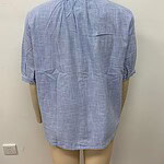 Light blue casual blouse made of lightweight fabric, featuring a relaxed fit and short sleeves, ideal for everyday wear and comfortable fashion.