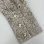 Close-up of a stylish women's shirt sleeve with a subtle pattern and four white buttons, showcasing high-quality fabric and craftsmanship.