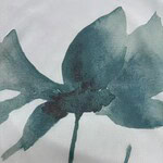 Close-up of a fabric with a watercolor butterfly design in shades of blue and teal, showcasing delicate artistic details.