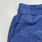 Close-up of blue lounge pants with floral pattern, elastic waistband, and relaxed fit, ideal for casual wear and comfort.