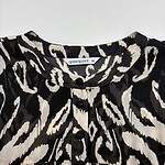 Stylish black and white animal print blouse with button details, perfect for trendy fashion looks and casual wear.