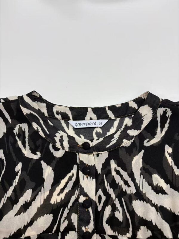 Stylish black and white animal print blouse with button details, perfect for trendy fashion looks and casual wear.