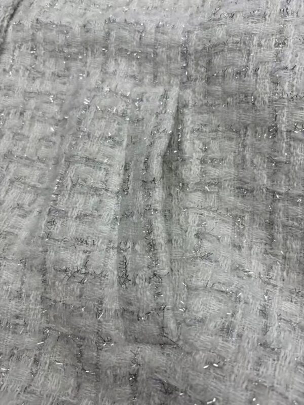 Close-up of a gray fabric with a textured, woven pattern, suitable for fashion or textile product displays.
