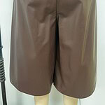 Stylish taupe leather shorts with a high waist and side pocket, perfect for casual or semi-formal occasions.