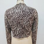Stylish zebra print knit sweater with long sleeves, perfect for casual wear and fashion-forward outfits.