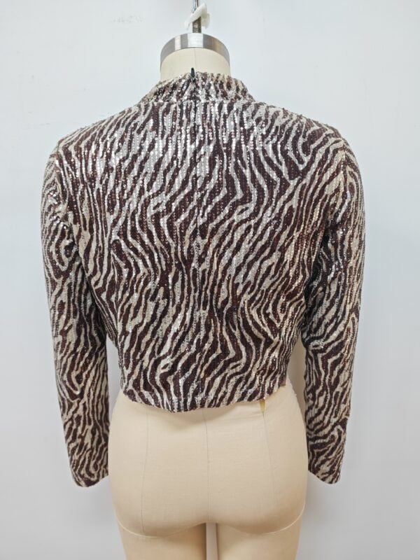 Stylish zebra print knit sweater with long sleeves, perfect for casual wear and fashion-forward outfits.