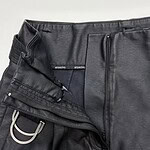Close-up of black leather pants with zipper and drawstring details, showcasing a sleek and modern design for fashionable men's wear.