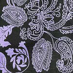 Close-up of a black fabric with intricate purple paisley and floral patterns, ideal for stylish clothing and accessories.