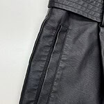 Close-up of black leather pants with zipper pocket, showcasing high-quality material and modern design for fashion-forward men.