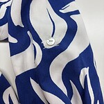 Close-up of a stylish blue and white patterned fabric with a button, ideal for fashion and textile design.