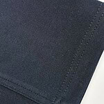 Detailed close-up of black fabric with visible texture and stitching, suitable for fashion or textile product images.