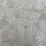Close-up of fabric with a beach shell pattern in neutral tones, ideal for fashion and home decor projects.