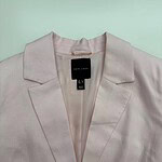 Light pink women's blazer with classic lapel design, perfect for professional or casual wear, made from high-quality fabric for a stylish look.