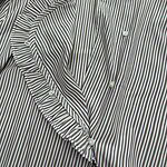 Close-up of a stylish women's blouse with vertical black and white stripes, ruffled collar, and button-down front, perfect for casual or office wear.