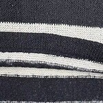 Detailed close-up of black and white striped fabric showing texture and pattern, ideal for fashion or textile design.