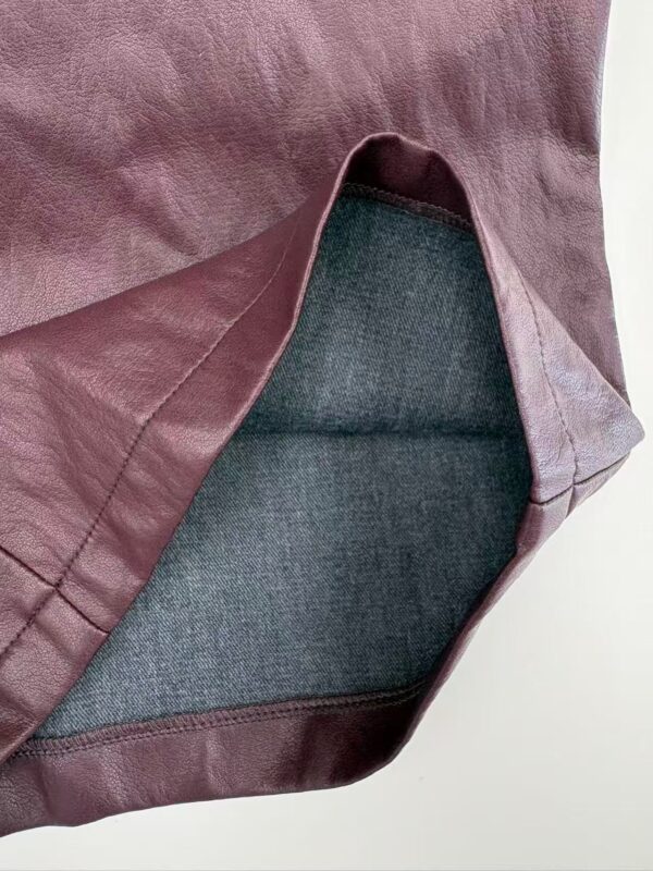 Close-up of a stylish women's leather skirt with a smooth finish and detailed stitching, perfect for fashion-forward outfits.