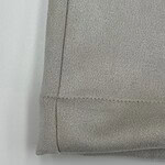 Close-up of a grey fabric sofa corner showing detailed stitching and smooth texture, ideal for modern living room decor.