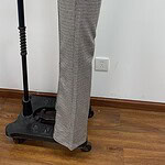 Close-up of women's checkered trousers with a black waistband, suitable for professional or casual wear, displayed on a mannequin.