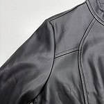 Close-up of a sleek black leather jacket with detailed stitching and modern design, perfect for fashion-forward men.