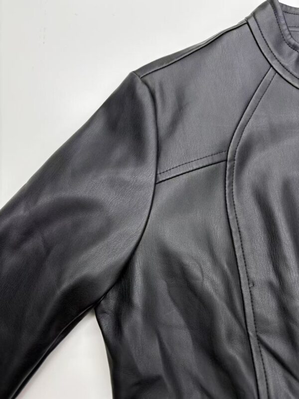 Close-up of a sleek black leather jacket with detailed stitching and modern design, perfect for fashion-forward men.