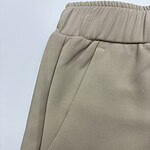 Close-up of beige casual women's pants with elastic waistband and side pocket, suitable for everyday wear and comfortable fashion.