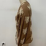 Stylish brown jacket with white floral patterns, long sleeves, and a relaxed fit, perfect for casual or semi-formal wear.