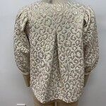 Elegant cream-colored women's jacket with textured pattern and puffed sleeves, suitable for formal or special occasions.
