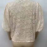 Cream-colored lace blouse with floral embroidery and puffed sleeves, perfect for formal or special occasions.