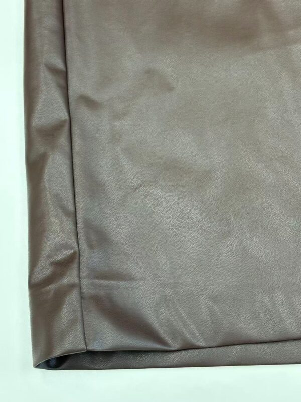 Close-up of taupe fabric with smooth texture, ideal for fashion and clothing projects.