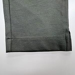 Close-up of a grey fabric with a smooth texture, suitable for fashion and apparel design, showcasing fine weave and quality material.