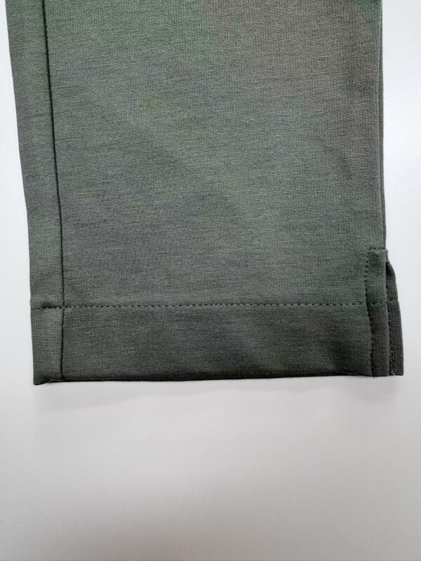 Close-up of a grey fabric with a smooth texture, suitable for fashion and apparel design, showcasing fine weave and quality material.