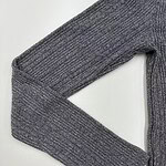Close-up of a grey knitted sweater with ribbed texture, perfect for casual or office wear, showcasing high-quality fabric and craftsmanship.