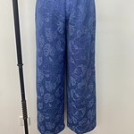 Stylish blue wide-leg pants with floral pattern, perfect for casual or summer wear, featuring an elastic waistband for comfort.