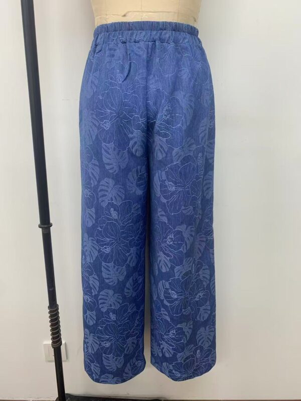 Stylish blue wide-leg pants with floral pattern, perfect for casual or summer wear, featuring an elastic waistband for comfort.