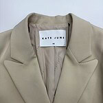 Elegant beige blazer by Kate June, XS size, perfect for professional and casual wear, featuring a classic lapel collar and tailored fit.