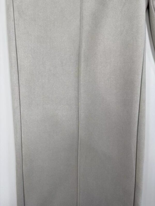 Close-up of light gray fabric with a smooth texture, suitable for formal dresses or suits.