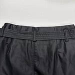 Close-up of black dress pants with belt loops, suitable for formal occasions and office wear, made from high-quality fabric.